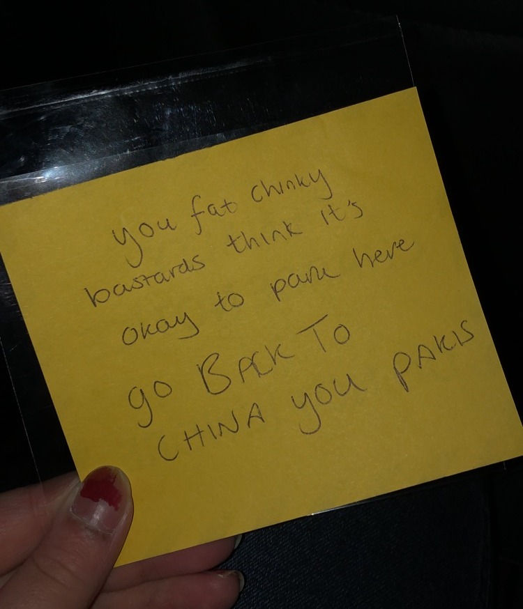 Note stuck on a car racially attacking me